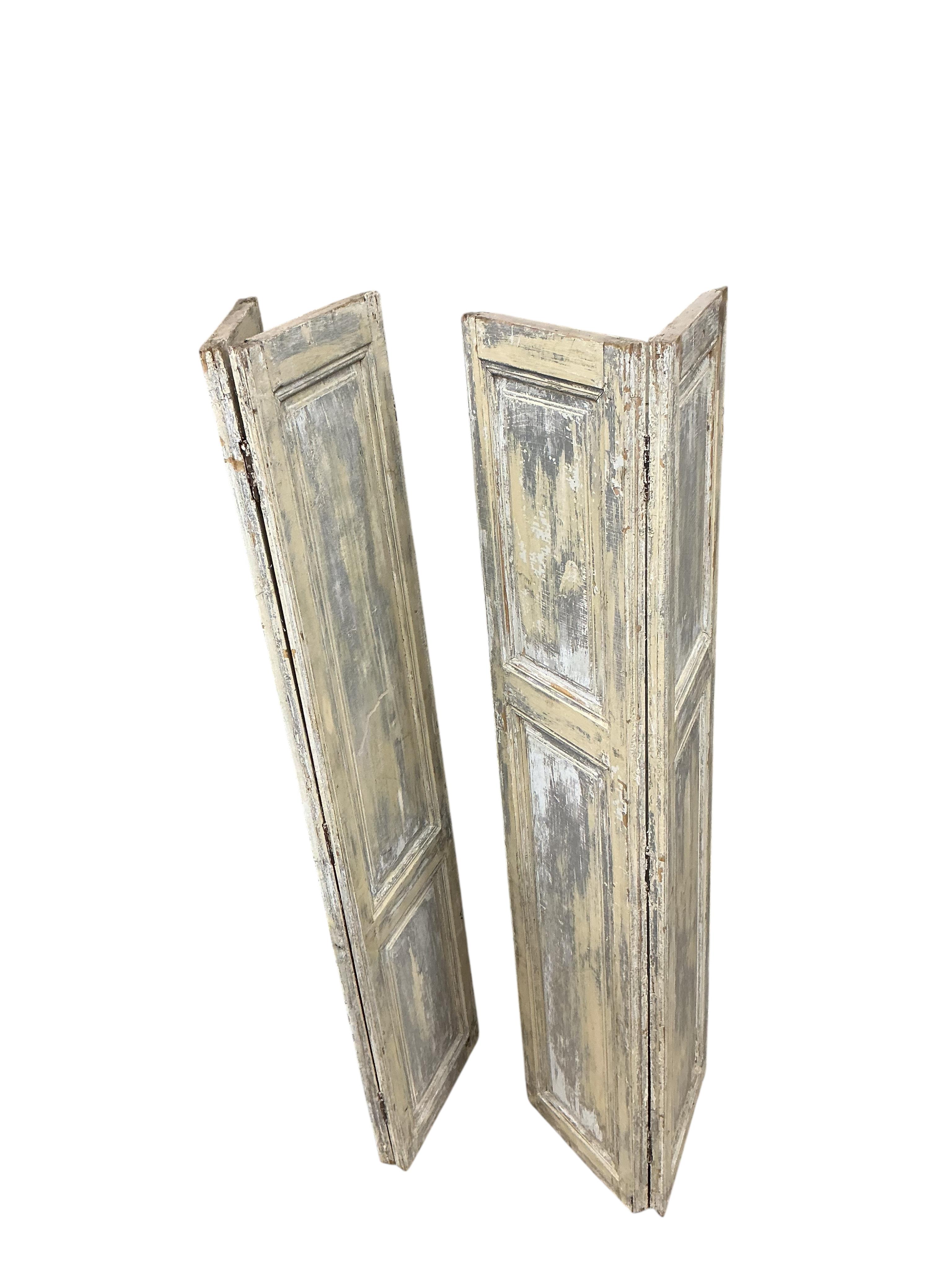 A pair of 19th century painted pine bi-fold shutters, each width 80cm, height 89cm